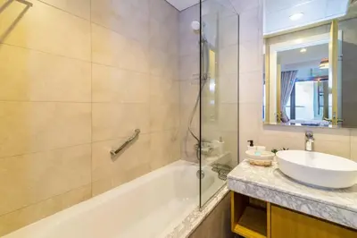a bathroom with a sink and a tub and a mirror at Samani vacation homes 5210 ocean view in Dubai