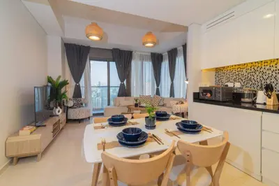 a kitchen and living room with a table and chairs at Samani vacation homes 5210 ocean view in Dubai