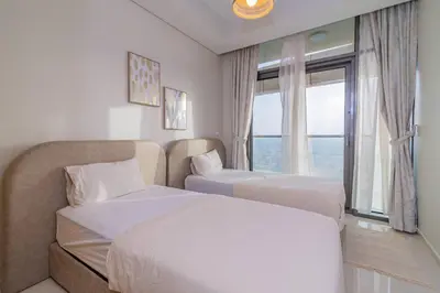 a hotel room with two beds and a window at Samani vacation homes 5210 ocean view in Dubai