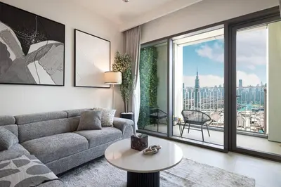a living room with a couch and a large window at Mahogany 14 - 2BR Dubai Mall Walk & Burj Khalifa in Dubai
