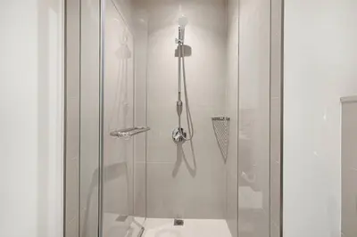 a bathroom with a shower with a toilet at Mahogany 14 - 2BR Dubai Mall Walk & Burj Khalifa in Dubai