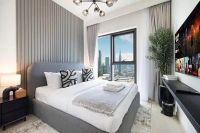 a bedroom with a large bed and a large window at Mahogany 14 - 2BR Dubai Mall Walk & Burj Khalifa in Dubai