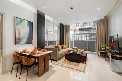 a living room with a couch and a table at Nice 2 Bedroom Apartment! 5 Minutes walk to Dubai Mall, Downtown Dubai in Dubai