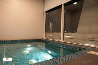 a swimming pool with a view of the city at Elevated Living Studio Facing the Burj in Dubai