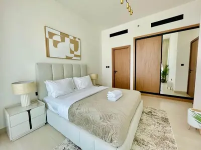 a bedroom with a large bed and a mirror at Opulent Nook 1br Designer Hideaway In Onyx in Dubai