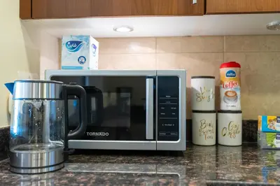 a kitchen counter with a microwave on a counter at Golden Mile at its Best 2BR Plus Maids Palm Jumeirah in Dubai