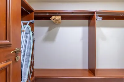 a closet with a wooden door with a hanger at Golden Mile at its Best 2BR Plus Maids Palm Jumeirah in Dubai