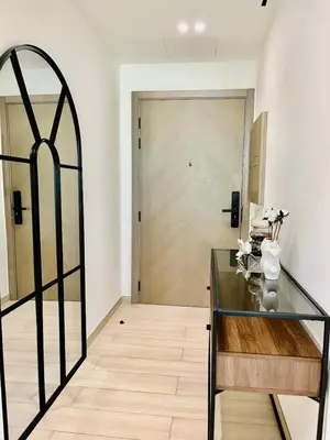 a room with a glass table and a door at Comfortable 1br In Jvc Balcony Free Parking in Dubai