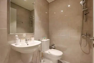 a bathroom with a toilet and a sink and a shower at Upgraded 3BR plus Maid's near Burj Khalifa & Dubai Opera in Dubai
