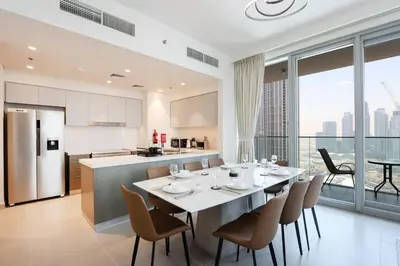 a kitchen and dining room with a table and chairs at Upgraded 3BR plus Maid's near Burj Khalifa & Dubai Opera in Dubai