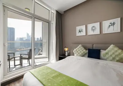 a bedroom with a bed and a large window at Stunning Canal View with Balcony in Dubai