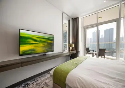 a bedroom with a bed and a tv on a wall at Stunning Canal View with Balcony in Dubai