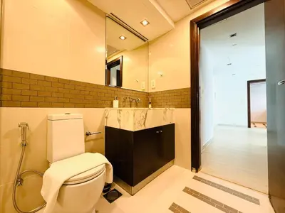 a bathroom with a toilet and a sink and a mirror at Vserve - 1 BR Escape in the Heart of Dubai Marina in Dubai