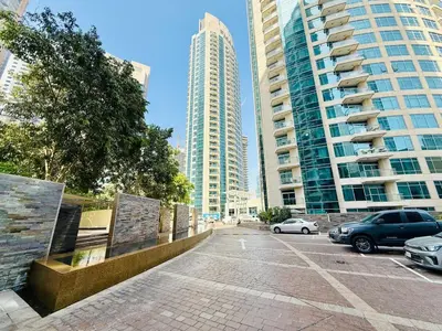 a parking lot in a city with tall buildings at Vserve - 1 BR Escape in the Heart of Dubai Marina in Dubai