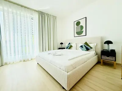 a white bedroom with a large bed and a large window at Vserve - 1 BR Escape in the Heart of Dubai Marina in Dubai
