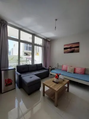 a living room with a couch and a table at Damac Hills 2- Relaxing 3BR townhouse - Homeyvillas in Dubai