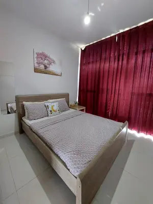 a bedroom with a bed in front of a red curtain at Damac Hills 2- Relaxing 3BR townhouse - Homeyvillas in Dubai