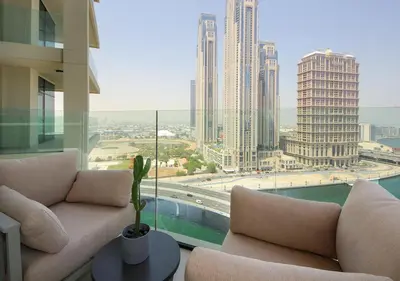 a living room with couches and a view of a city at Luxury 2BR in Urban Oasis by Missoni on High Floor in Dubai