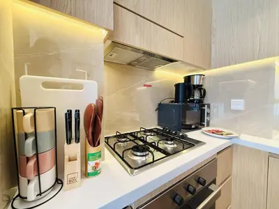 a kitchen with a stove and a counter top at Vserve - Peaceful 1 BR Getaway in Vibrant JVC in Dubai