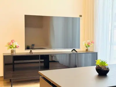 a large flat screen tv in a living room at Vserve - Peaceful 1 BR Getaway in Vibrant JVC in Dubai