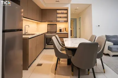 a kitchen and dining room with a table and chairs at Burj Crown Luxury 2BR W Balcony & Pool View 8th Floor in Dubai