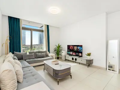 a living room with a couch and a tv at Burj Crown Luxury 2BR W Balcony & Pool View 8th Floor in Dubai