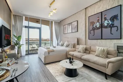 a living room with a couch and a table at Trendy Studio Apartment in Binghatti Crystals in Dubai