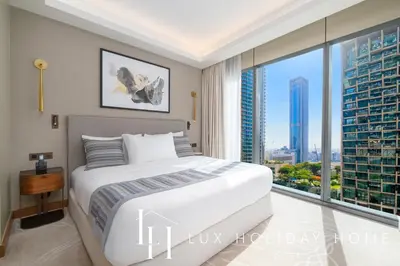 a bedroom with a large bed and a large window at LUX The Address Opera Downtown Suite in Dubai