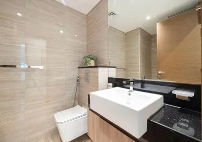 a bathroom with a white sink and a toilet at Luxury 2 BR Missoni Building Canal & Pool View in Dubai