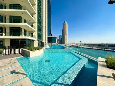 a swimming pool in the middle of a building at Luxury 2 BR Missoni Building Canal & Pool View in Dubai