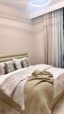 a bedroom with a bed with a blanket on it at Luxurious Crown - Downtown - Fountains View in Dubai