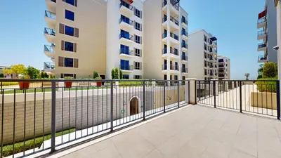 a fence with a gate in front of a building at La Sirene 2 - Magnificient Two Bedroom in La Mer in Dubai