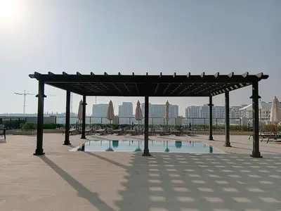 a pavilion with a pool of water in a park at La Sirene 2 - Magnificient Two Bedroom in La Mer in Dubai