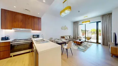 a kitchen and living room with a table and a couch at La Sirene 2 - Magnificient Two Bedroom in La Mer in Dubai