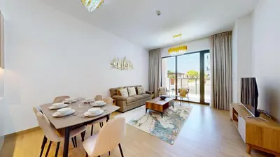 a living room with a dining table and a couch at La Sirene 2 - Magnificient Two Bedroom in La Mer in Dubai