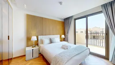 a bedroom with a large bed and a large window at Elegant - Three Bed Villa in Jumeirah Golf Estate in Dubai