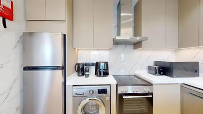 a kitchen with a stainless steel refrigerator and a dishwasher at Stunning One Bedroom in the Marina in Dubai
