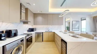 a kitchen with a washer and dryer in a room at Stunning One Bedroom in the Marina in Dubai