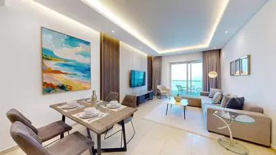 a living room with a couch and a dining room at Vacationer I Elegant 2 Bed I City View I Close to Barasti Beach I Marina Heights in Dubai