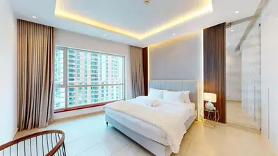 a bedroom with a large bed and a large window at Vacationer I Elegant 2 Bed I City View I Close to Barasti Beach I Marina Heights in Dubai