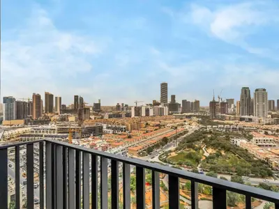 a view of a city skyline from a balcony at NEW Luxury 2 Bed in Belgravia Heights in JVC in Dubai