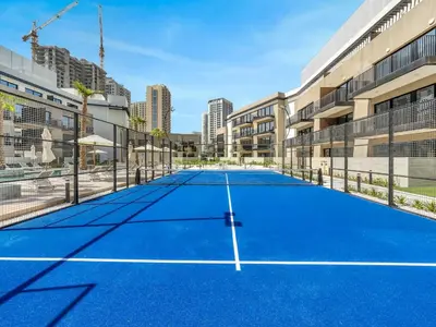 a tennis court in the middle of a building at Brand New Luxury Apartment in JVC with Padel Court in Dubai