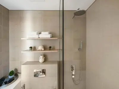 a bathroom with a shower with a glass door at Brand New Luxury Apartment in JVC with Padel Court in Dubai