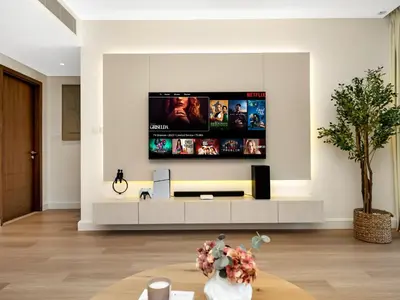 a living room with a flat screen tv on the wall at The Dubai Mall Suite Luxury 1-Bed Near Burj Khalifa in Dubai