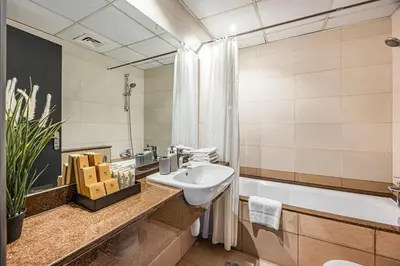 a bathroom with a sink and a tub at Luxury 2BR Haven with Expansive Terrace and Elegance in Dubai