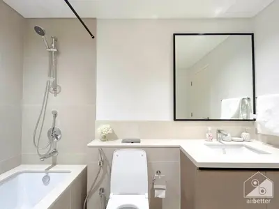 a bathroom with a toilet and a sink and a mirror at Luxury 4BR Apartment at Burj Crown I Balcony Views in Dubai