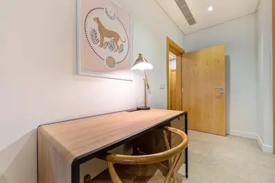 a desk in a room with a lamp and a chair at Breathtaking 1BR Sea-View Palm Apt Beach & Pool in Dubai