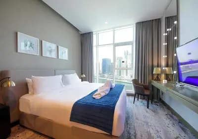 a hotel room with a bed and a large window at Elegant Studio in Business bay Near Dubai Mall in Dubai