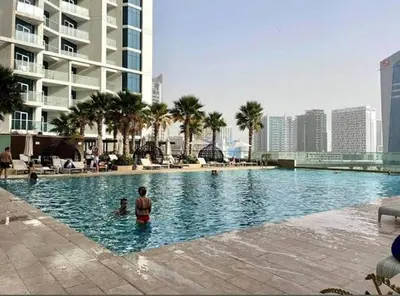 a man standing in a swimming pool in a city at Elegant Studio in Business bay Near Dubai Mall in Dubai