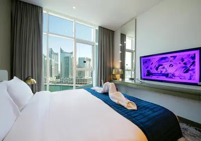 a hotel room with a large bed and a large tv at Elegant Studio in Business bay Near Dubai Mall in Dubai